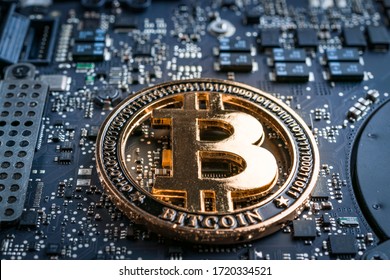 Cryptocurrency background. Gold Bitcoin Computer electronic circuit board motherboard. CryptoCash Mining and electronic money concept.
