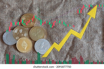 Cryptocurrency bitcoin and altcoins coin, up arrow  on a burlap background and chart. Investment concept