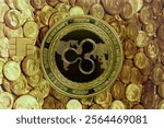 Cryptocurrency concept. A close up shot of Ripple XRP cryptocurrency coin on top of a credit card with a picture of ancient gold coins. selective focus in the center.