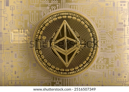 Cryptocurrency concept. A macro shot of EOS cryptocurrency coin on top of a golden printed PCB circuit.