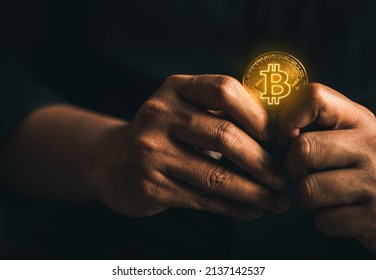 cryptocurrency golden bitcion. hand holding gold bitcoin - virtual Btc neon sign for trading web  and international network payment. 