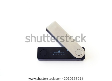 Cryptocurrency hardware wallet locked screen ready for user to enter pin code to login. Cryptocurrency hardware wallet USB isolated on white background.