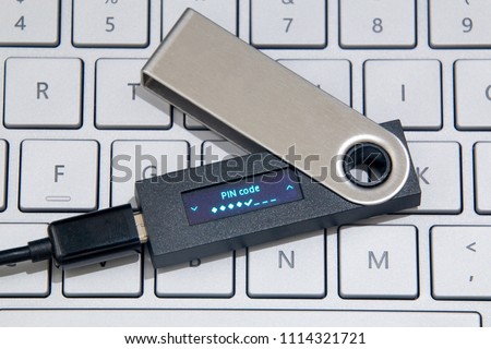 Cryptocurrency Hardware Wallet On Laptop Keyboard