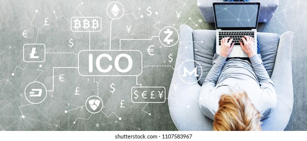 Cryptocurrency ICO Theme With Man Using A Laptop In A Modern Gray Chair