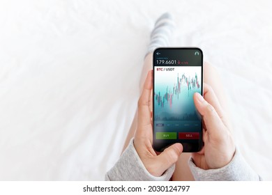 Cryptocurrency Investment Concept. Person Using Mobile Phone on Bed at Home to Buy and Sell Bitcoin via Online Exchange Platform. Blockchain,Fintech Technology. Innovation of Financial Investment - Powered by Shutterstock