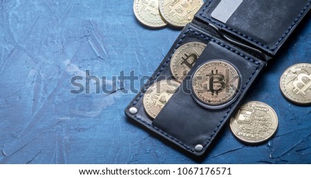 Crypto-currency: Leather wallet with metal bitcoin coins