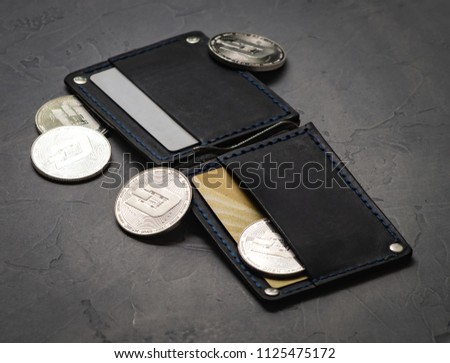 Crypto-currency: Leather wallet with metal dashcoin coins.