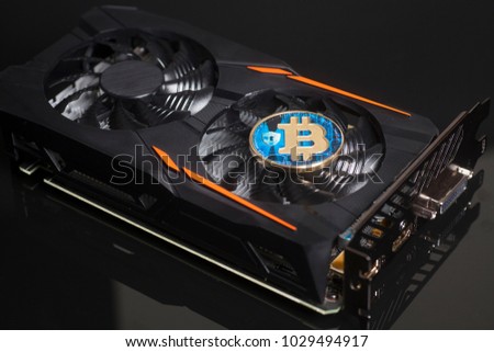 Cryptocurrency mining concept with bitcoin on a videocard 