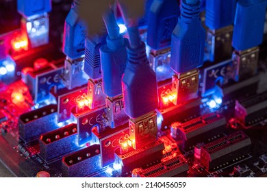 Cryptocurrency and money mining with help of Internet technologies close-up. Neon LED backlight on motherboard for cryptocurrency mining using crypto farm. - Shutterstock ID 2140456059