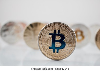 Cryptocurrency physical gold bitcoin coin with blue sign.