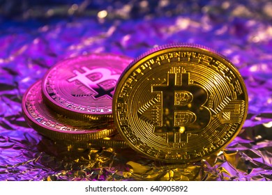 Cryptocurrency physical golden bitcoin coin on colorful background