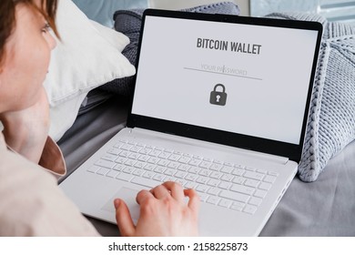 Cryptocurrency Security Login. Female Lying On The Bed In Her Room Entering Password To Enter Crypto Wallet On Laptop