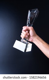 Crystal Award On Hand Isolated On Black Background