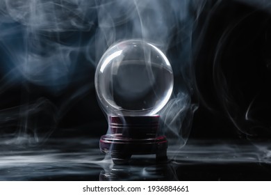 Crystal Ball Of Fortune Teller In Smoke On Dark Background