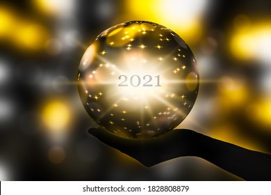 Crystal Ball In A Hand, Prediction For New Year 2021 On Abstract Shiny Blurred Background