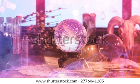 Crystal ball and magic attributes on table