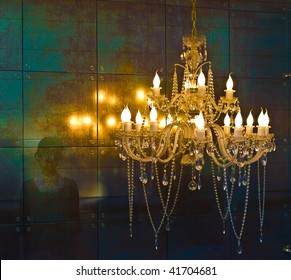 Crystal chandelier lighting near the mirror wall