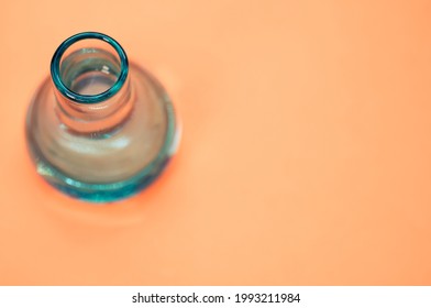 A Crystal Flower Vase Isolated On A Pastel Orange Background With Free Space For Text