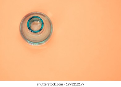 A Crystal Flower Vase Isolated On A Pastel Orange Background With Free Space For Text