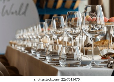 crystal glasses on a served table in a restaurant, glassware for dinner