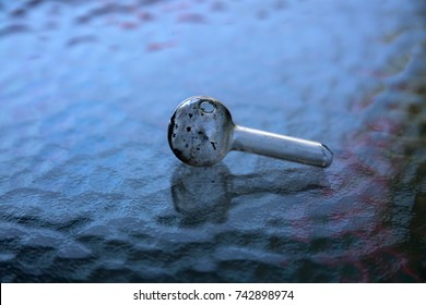 Crystal Meth Pipe. A Glass Pipe For Smoking Methamphetamine Found On A Sidewalk. Drug Abuse. 