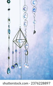 Crystal prisms on abstract blurred light natural background. Magic Ritual with crystal sun catcher. crystal practice for positive spirit, harmony, calming, productive the mind. Witchcraft. Feng Shui