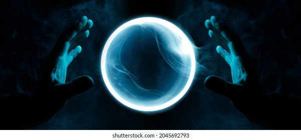 Crystal sphere in hands. Magic ball predictions. Mysterious composition. Fortune teller, mind power, prediction, halloween concept. Wide angle horizontal wallpaper or web banner. Mockup for your logo.