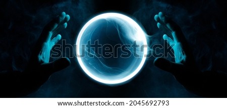Crystal sphere in hands. Magic ball predictions. Mysterious composition. Fortune teller, mind power, prediction, halloween concept. Wide angle horizontal wallpaper or web banner. Mockup for your logo.