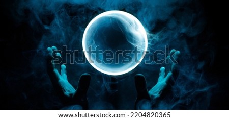 Crystal sphere in hands. Magic ball predictions. Mysterious composition. Fortune teller, mind power, prediction, halloween concept. Wide angle horizontal wallpaper or web banner. Mockup for your logo.