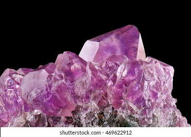 Crystal Stone macro mineral, purple rough amethyst quartz crystals on black background