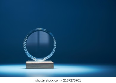 crystal trophy against blue background with copy space           