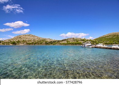 Crystal water. Boat on dock. Islands of the Kornati archipelago national park in Croatia.