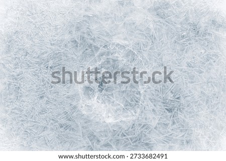 Crystalized ice background texture with cracks in a web-style in a light-blue tone.