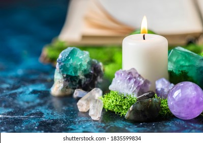 Crystalline minerals for meditation, candle, moss, book. Magic Rock for Healing stones. Copy space