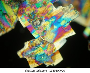 Crystallized Liquid Crystal Under Polarized Light Microscope Forming A Rainbow Texture. Abstract Squares Filled With Rainbow Colors.