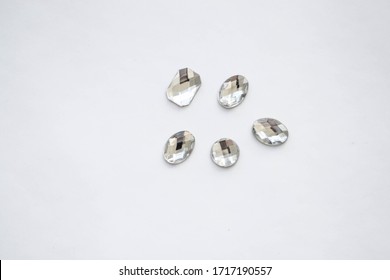 Crystals. Crystal rhinestones on a white background. Beautiful shiny sparkling white rhinestones. Isolated. Jewelry, rhinestones, shiny stones.