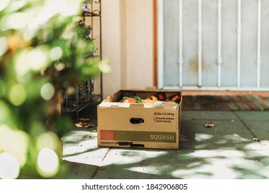 CSA Farmer’s Box Full Of Produce On Front Porch