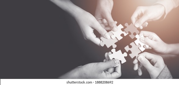 CSR (coporate social responsibility) or teamwork concept.Hands holding jigsaw.Autism awareness day kid child.business people putting jigsaw for team together.Charity, volunteer. Unity, team business. - Shutterstock ID 1888208692