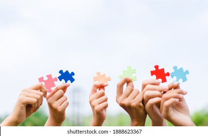 CSR (coporate social responsibility) teamwork.Hands holding jigsaw.Autism awareness, Autism spectrum disorder family support concept, World Autism Awareness Day.Charity, volunteer. Unity, team.