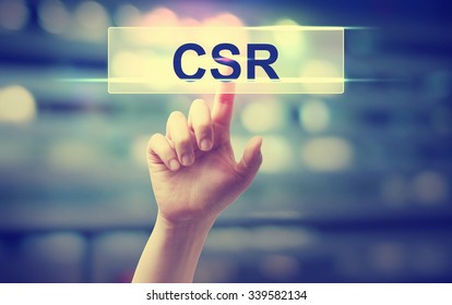 CSR - Corporate Social Responsibility Concept With Hand Pressing A Button On Blurred Abstract Background 