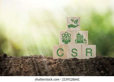 CSR Corporate Social Responsibility, CSR And Sustainability Responsible Office. Wooden Cube With The CSR Icon Of Natural Resource, Production, Product, Usage, Reuse And Recycling Standing. 