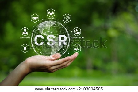 CSR icon concept in the hand for business and organization, Corporate social responsibility and giving back to the community on a green nature background.