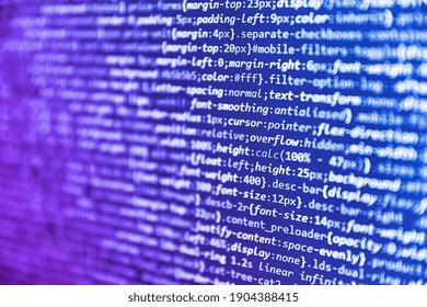 Css3 code on a colorful background. Programming, webdesign HTML printed code. Programmer workplace. Database bits access stream visualisation. Writing program code on computer