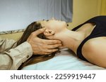 
a CST treatment session for a woman, Osteopathic Manipulation and CranioSacral Therapy. Non-traditional medicine. Health care and head massage