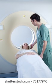 A CT Scan Machine With Patient And Nurse