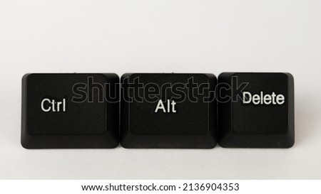 Ctrl alt delete shortcut text created with keyboard keys isolated on white bckground, computer terminology, white Ctrl alt delete letters on black keyboard, top view