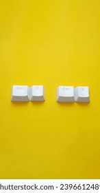 Ctrl C, Ctrl V keyboard buttons, copy and paste key shortcut isolated on a yellow background.