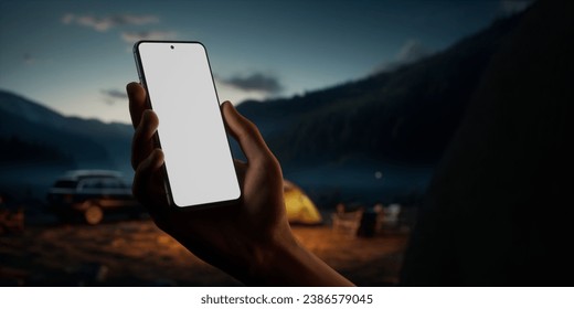 CU Caucasian male using his phone near campsite in the evening. Blank screen travel, weather application smartphone mockup - Powered by Shutterstock