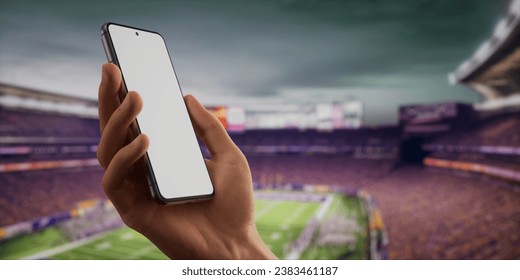 CU Caucasian man using his phone during American football game on a huge stadium. Online betting, sports application blank screen smartphone mockup - Powered by Shutterstock