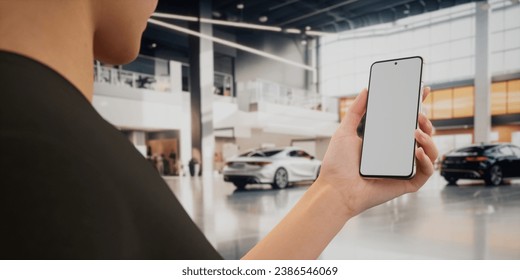 CU Caucasian woman using his phone inside the car dealership. Insurance, banking, online marketplace blank screen smartphone mockup - Powered by Shutterstock